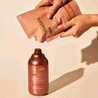 refilling lotion bottle with rose lotion